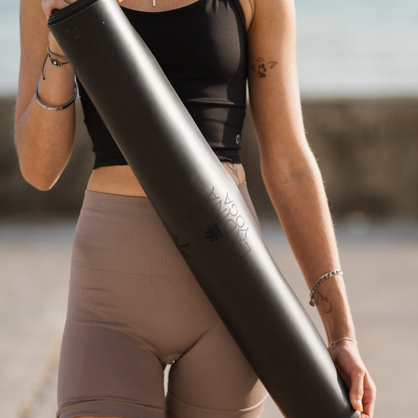 Load image into Gallery viewer, Ladina Yoga Warrior Black travel yoga mat rolled holding
